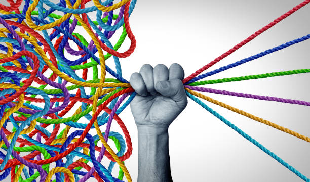 Hand organizing tangled ropes into organized colorful threads